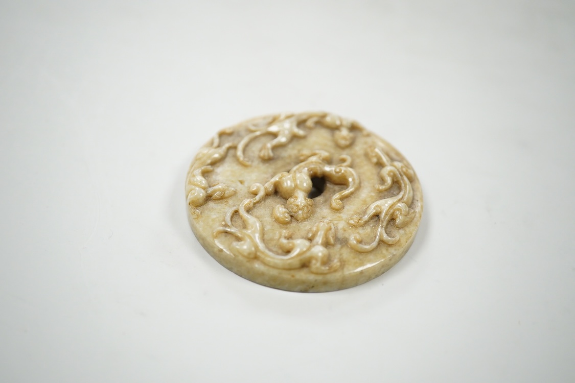 A Chinese russet jade bi disc, 5cm diameter